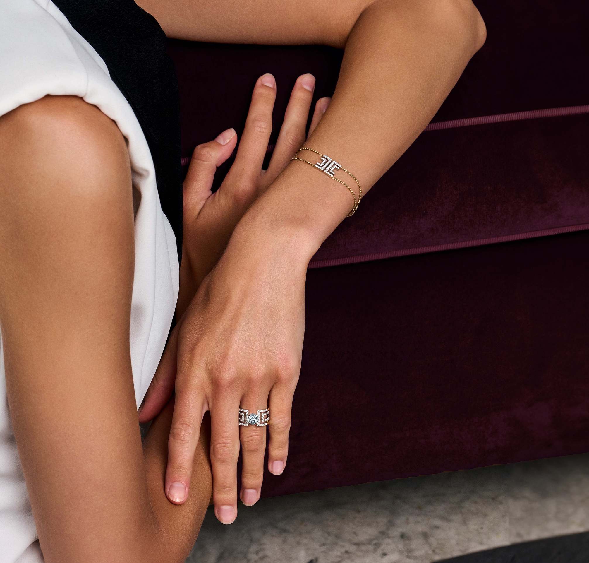 A close-up of woman's arm wearing jewellery, namely the Harper Bracelet and Heloise Round ring.